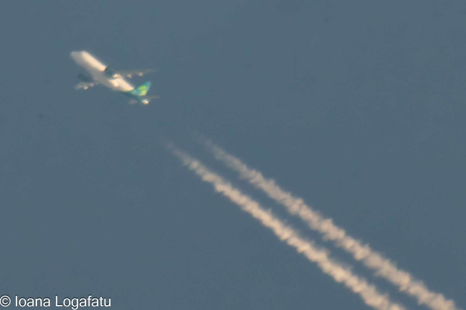 High above the clouds, a jet leaves its mark